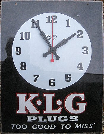 K.L.G. PLUGS GLASS CLOCK - click to enlarge